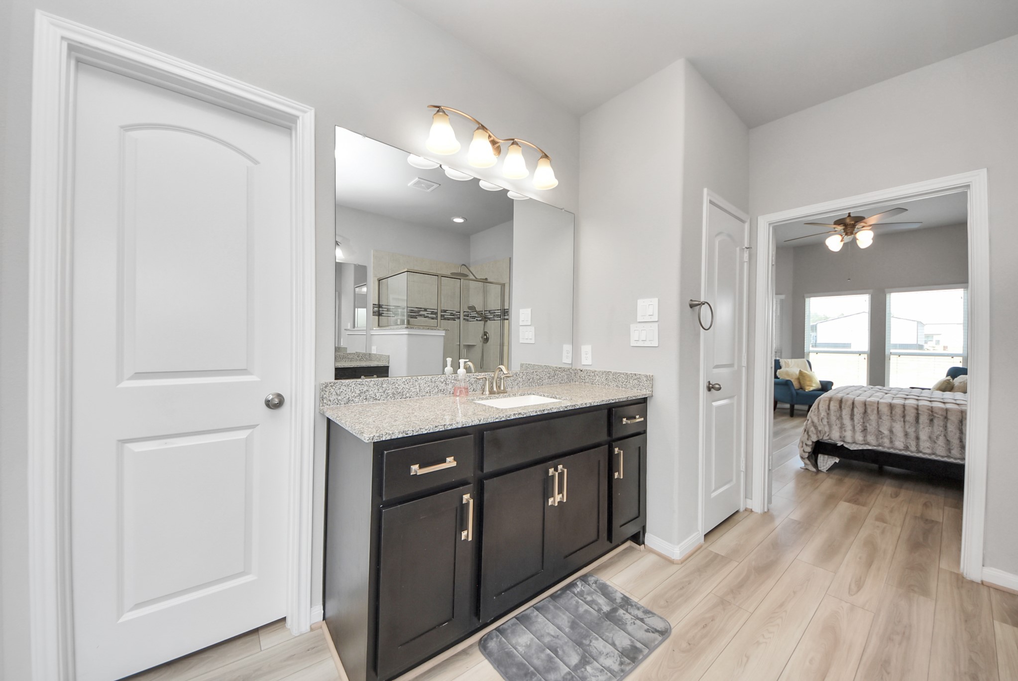16735 Rockwall Street Conroe, TX 77303 - Photo 19 of 37 a spacious bathroom with a double vanity sink and a mirror