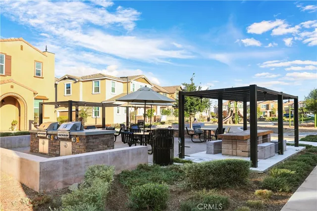 a living room with patio furniture and a large window
