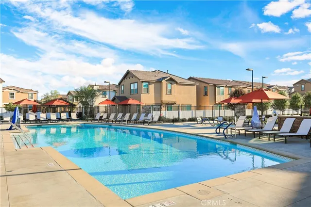 a view of a patio with a dining table and chairs under an umbrella