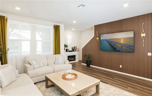 a living room with furniture kitchen view and a table