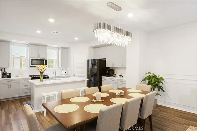 a view of a dining room with furniture and wooden floor