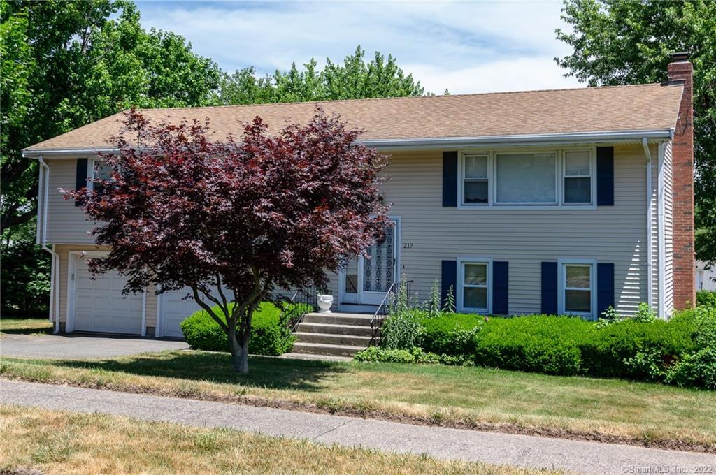 217 Ridge Crest Circle Wethersfield, CT 06109 - Photo 1 of 1 a view of a house with a garden