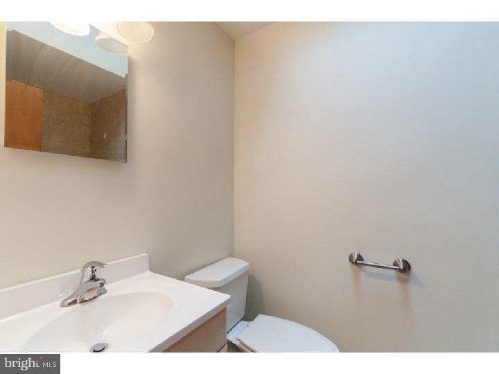 1307 Adair Road Brookhaven, PA 19015 - Photo 22 of 25 a bathroom with a sink and mirror