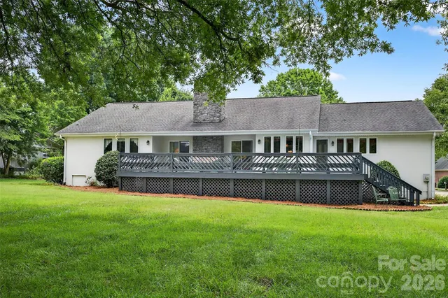 a front view of a house with a yard and green space