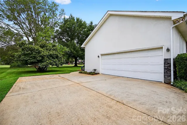a view of backyard of house and garage