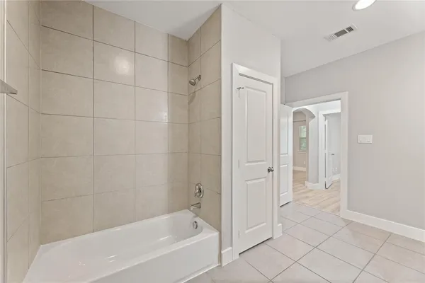 a bathroom with a bathtub and shower