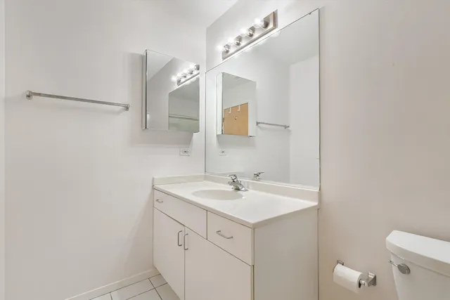 a bathroom with a sink a mirror and a toilet
