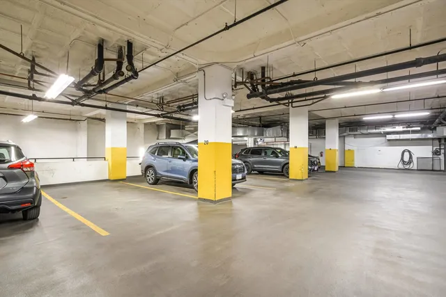 a view of parking garage with cars