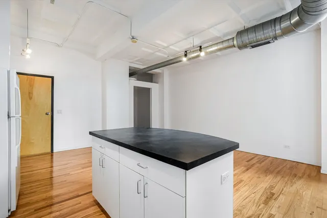a kitchen that has a microwave a sink and a stove in it