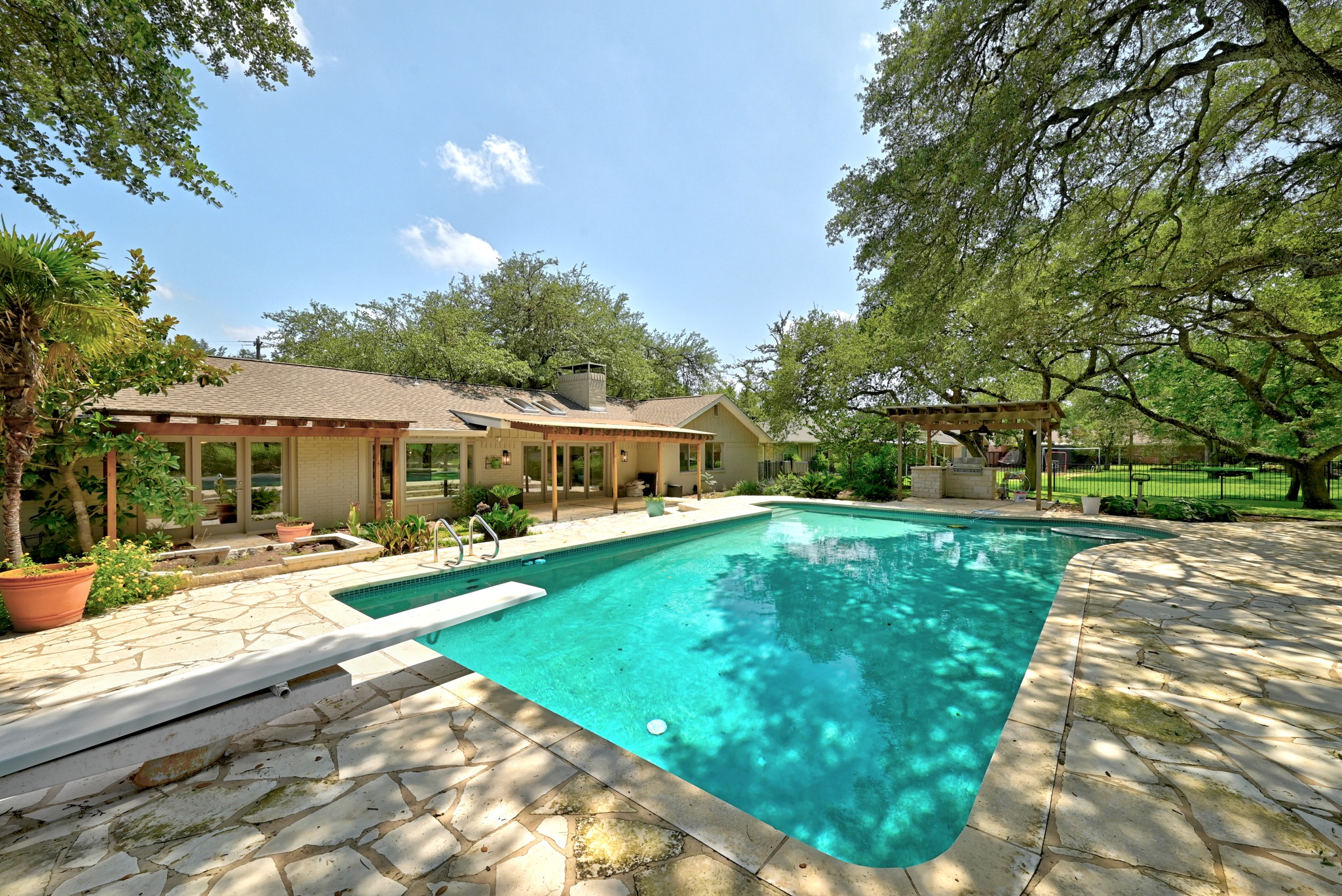 8608 Crest Ridge Circle Austin, TX 78750 - Photo 31 of 38 An inviting backyard oasis awaits, complete with a refreshing swimming pool and a sprawling natural stone patio.