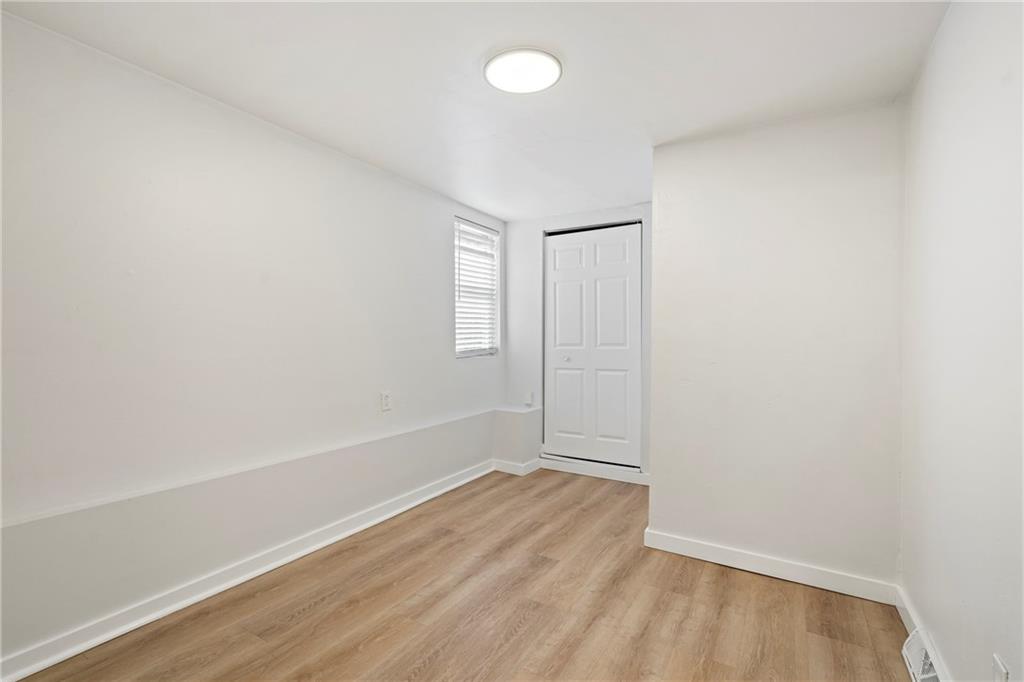 5140 Butler Street Pittsburgh, PA 15201 - Photo 9 of 25 an empty room with wooden floor and windows