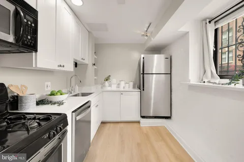 a kitchen with a sink a stove and refrigerator