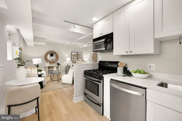 a kitchen with a stove a sink and a microwave