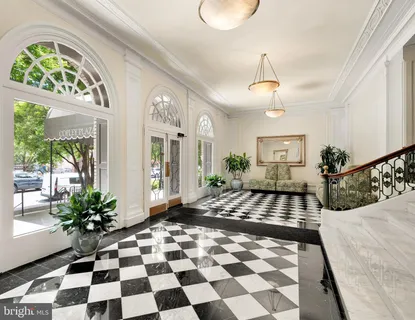 a view of a entryway with a flower pot and a rug