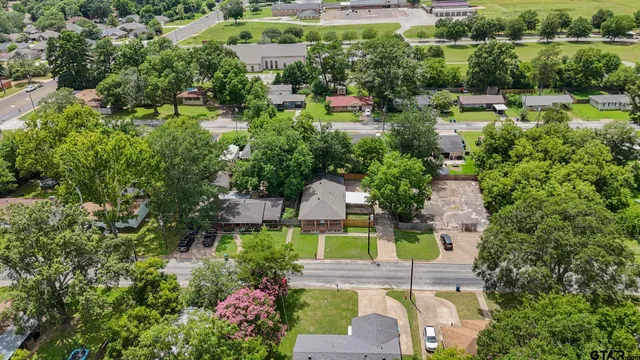 an aerial view of a house with a yard fountain and outdoor seating