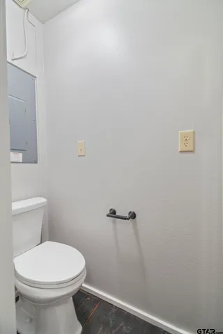a white toilet sitting next to a white sink