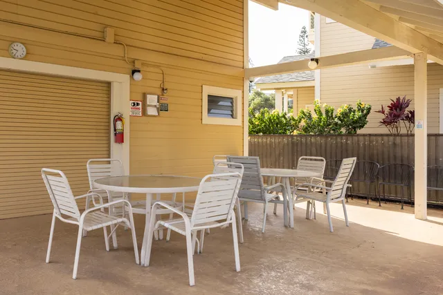 a view of a patio with table and chairs and potted plants