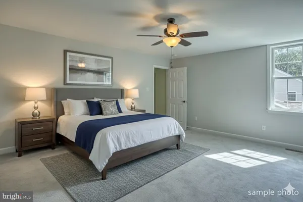 a bedroom with a bed and a painting on the wall