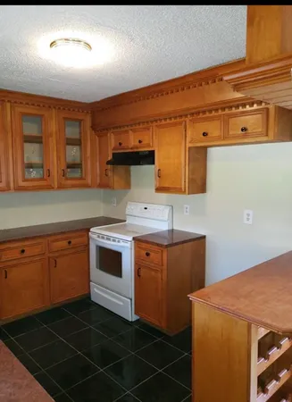 a kitchen with a sink stove and cabinets