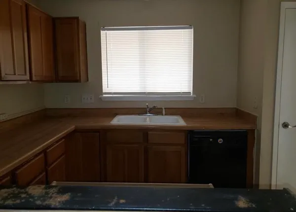 a kitchen with a sink and cabinets