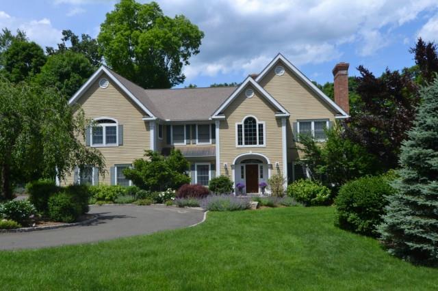 71 East Meadow Road Wilton, CT 06897 - Photo 1 of 1 a front view of a house with a yard and trees