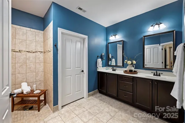 a spacious bathroom with a double vanity sink and a mirror