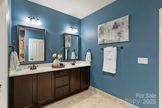 a bathroom with a sink vanity and mirror