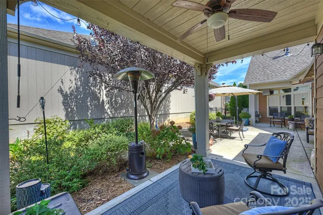 a view of a patio with plants and chairs