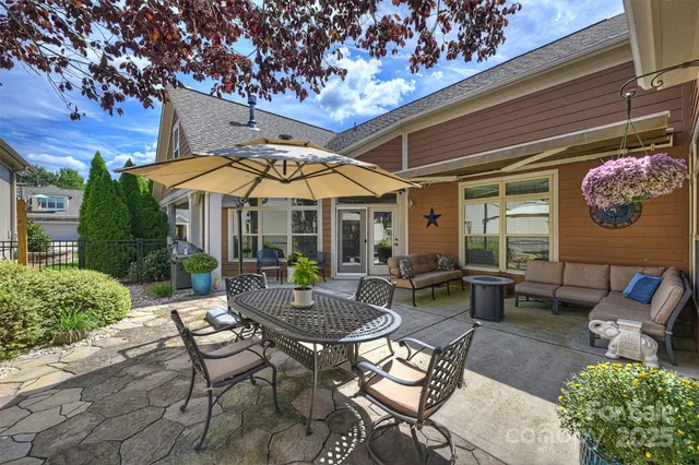 a patio with a table and chairs under an umbrella