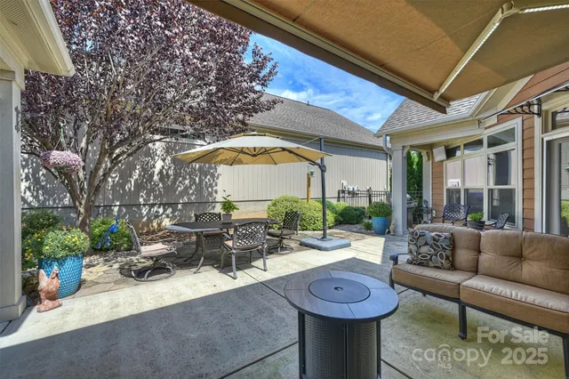 a view of swimming pool with outdoor seating and plants