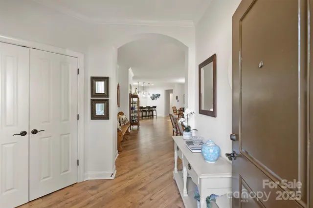 a dining room with wooden floor and white walls