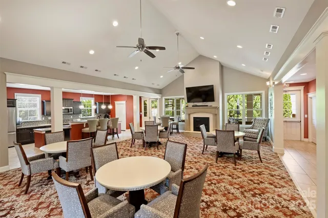 a living room with fireplace furniture and a large window