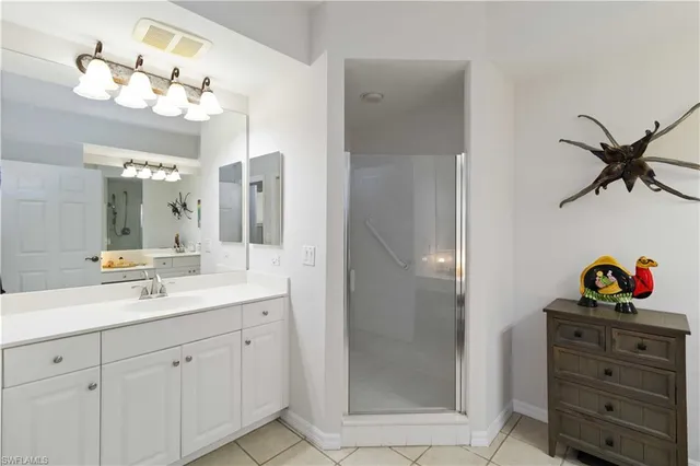 a bathroom with a shower sink and mirror