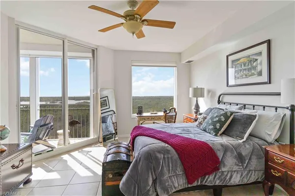 a bedroom with a bed window and couch