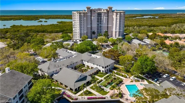 a living room with furniture and floor to ceiling windows
