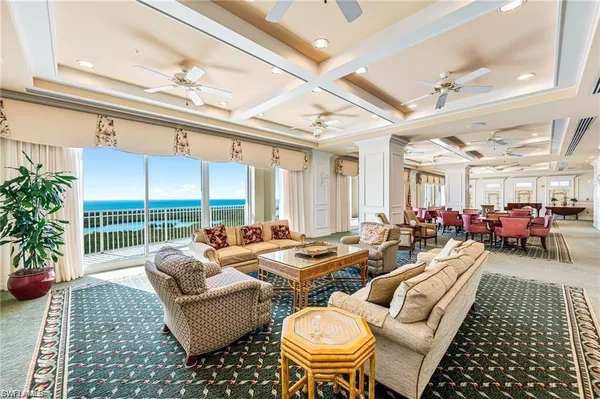 a living room with furniture and a floor to ceiling window