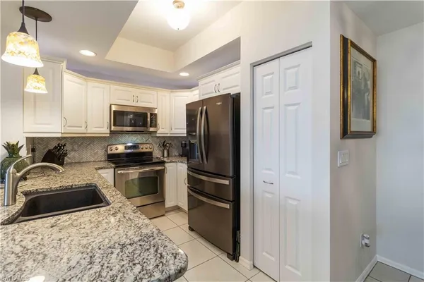 a kitchen with a refrigerator stove and sink