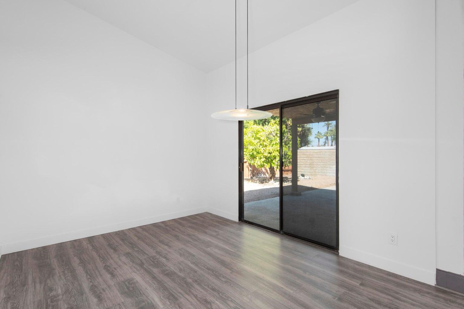28 Chandra Lane Rancho Mirage, CA 92270 - Photo 11 of 13 an empty room with wooden floor and sliding door