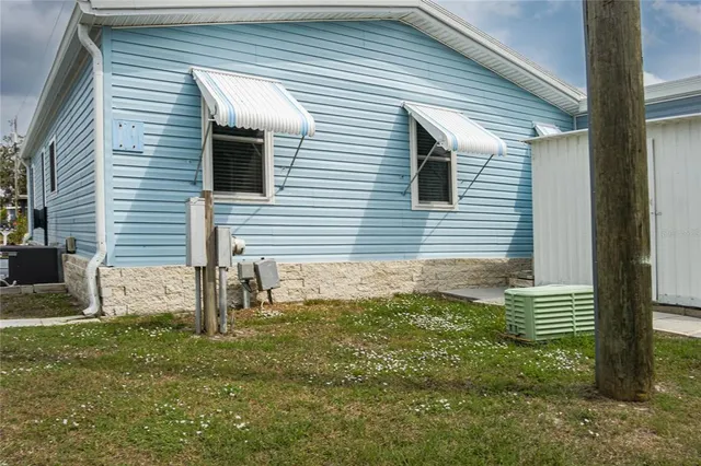 a view of a parking space in back of the house