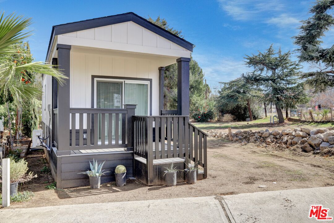 17650 Grand Avenue, Unit 114 Lake Elsinore, CA 92530 - Photo 1 of 1 a view of a house with a small yard and plants