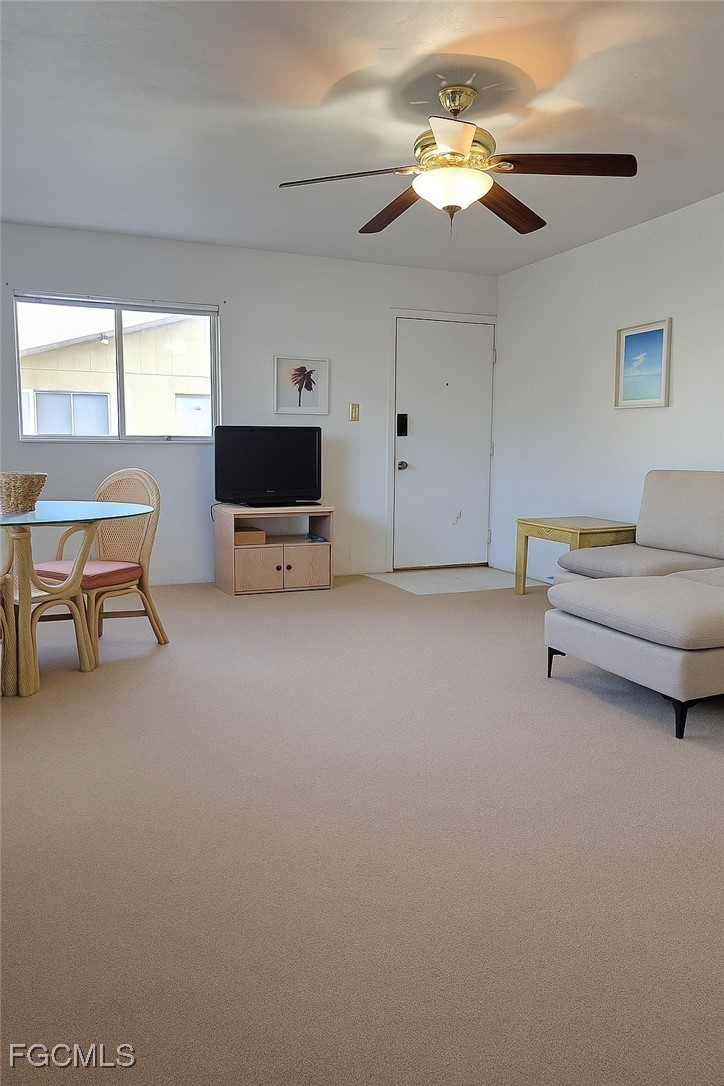8135 Country Road, Unit 206 Fort Myers, FL 33919 - Photo 3 of 11 a living room with furniture and a flat screen tv