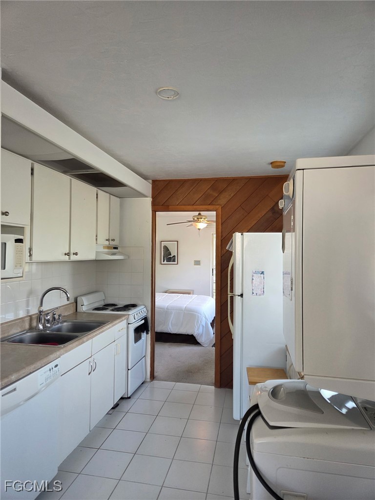 8135 Country Road, Unit 206 Fort Myers, FL 33919 - Photo 5 of 11 a kitchen with a sink appliances and cabinets