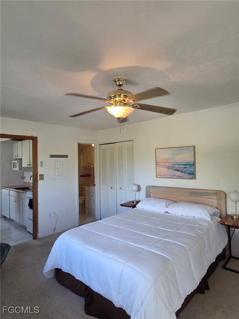 8135 Country Road, Unit 206 Fort Myers, FL 33919 - Photo 7 of 11 a bedroom with a bed and a chandelier