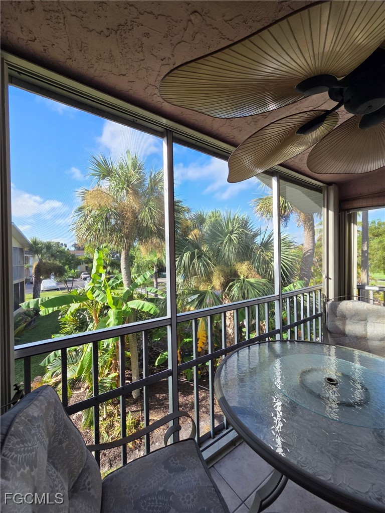 8135 Country Road, Unit 206 Fort Myers, FL 33919 - Photo 9 of 11 a view of a porch with wooden floor