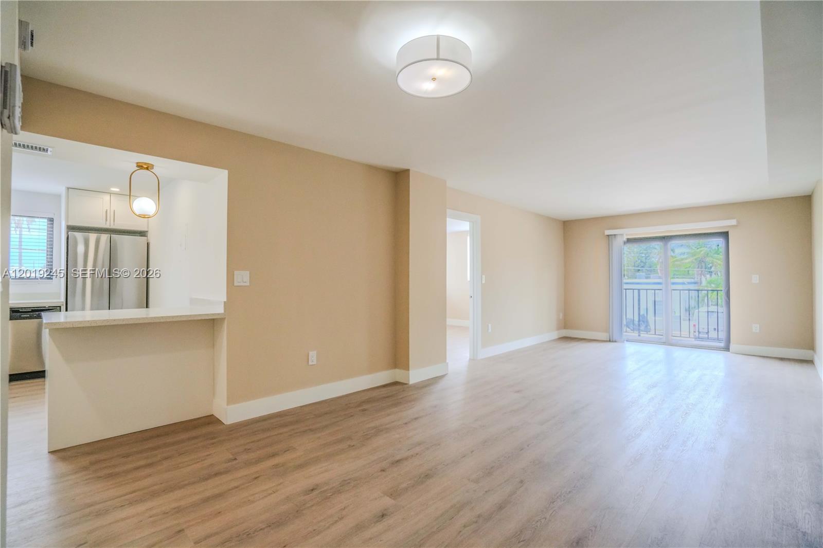 6960 Rue Vendome, Unit 201 Miami Beach, FL 33141 - Photo 2 of 27 an empty room with wooden floor and windows