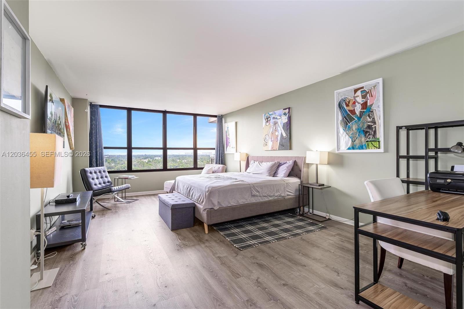 780 Northeast 69th Street, Unit 1010 Miami, FL 33138 - Photo 23 of 31 a bedroom with a bed a table and a dresser next to a window