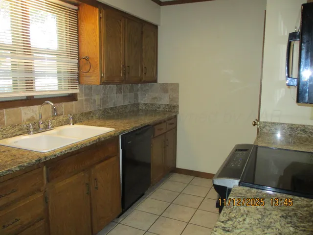 a kitchen with a sink and a window