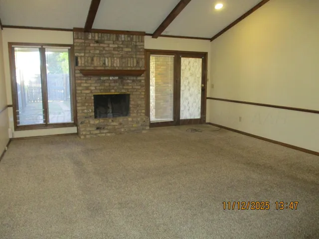 a view of an empty room with a fireplace