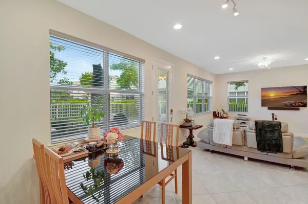 a living room with furniture a flat screen tv and a large window