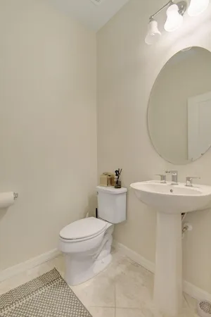a bathroom with a sink a toilet and mirror